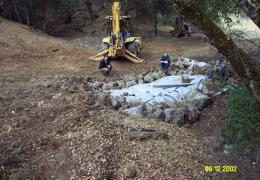 Keyways are dug, lined with fabric and backfilled with large armor at the upstream & downstream end of the crossing's fillslope