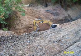 During: An excavator is used to remove the old drainage structures and the aggraded sediment upstream of the crossing