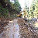 Excavation of sidecast fill and in-place outsloping during road to trail conversion