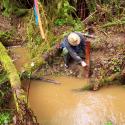 PWA hydrologist installing a staff plate to monitor discharge in a tributary to Ryan Creek