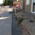 Recently installed permeable sidewalk is shown prior to retaining wall construction and landscaping.